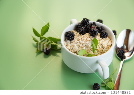 Vegan porridge with berries in a white bowl Vegan porridge with berries in a white bowl 131448881