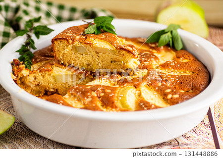 Ruddy apple pie with mint and golden crust close-up 131448886