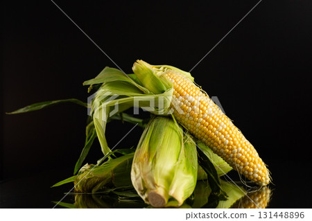 organic sweet corn on black background 131448896