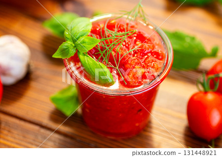 Fresh tomatoes garlic basil and herbs on wooden table Fresh tomatoes garlic basil and herbs on wooden table 131448921