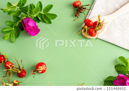 Top view of ripe rose hips on a green background 131448932