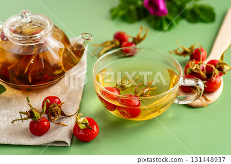 hot tea in a cup made from rose hips with flowers and berries hot tea in a cup made from rose hips with flowers and berries 131448937