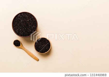 quinoa seeds in bowl and spoon on colored background. Healthy kinwa in small bowl. Healthy superfood 131448969