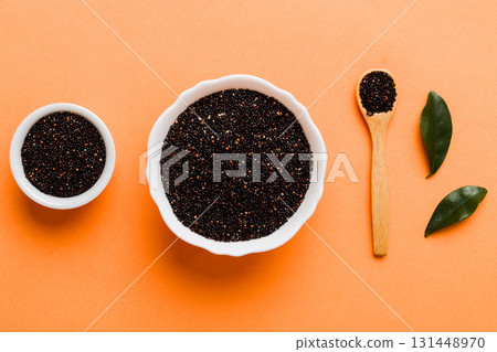 quinoa seeds in bowl and spoon on colored background. Healthy kinwa in small bowl. Healthy superfood 131448970