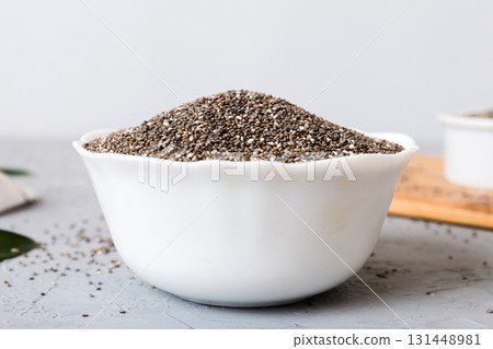 Chia seeds in bowl on colored background. Healthy Salvia hispanica in small bowl. Healthy superfood 131448981