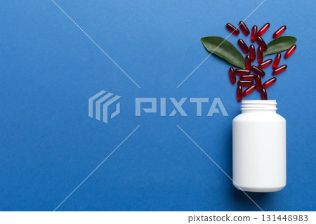 different drugs and health supplement pills poured from a medicine bottle health care and medical top view on colored background different drugs and health supplement pills poured from a medicine bottle health care and medical top view on colored background 131448983