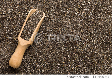 Space for text Texture of chia seeds with wooden spoon, superfood concept. Top view Space for text Texture of chia seeds with wooden spoon, superfood concept. Top view 131448987