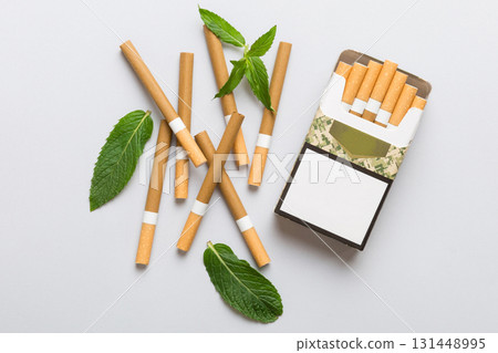 Pack of menthol cigarettes and fresh mint on colored table, Menthol cigarettes top view flat lay 131448995