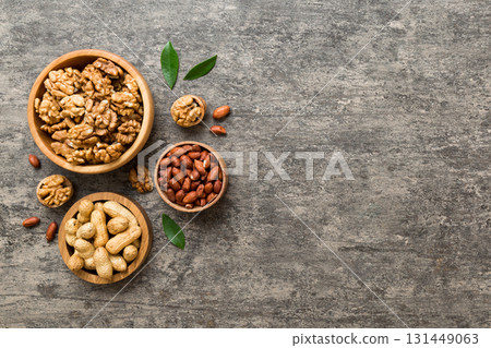 Walnut kernel halves, in a wooden bowl. Close-up, from above on colored background. Healthy eating Walnut concept. Super foods with copy space 131449063