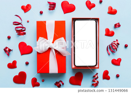 Opened gift box with ribbon and phone on color background, top view. Blank open box packaging mockup , Template for your design - branding mockup Opened gift box with ribbon and phone on color background, top view. Blank open box packaging mockup , Template for your design - branding mockup 131449066