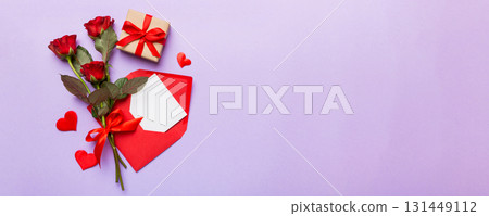 Valentine day composition with Envelope, rose flower and Red heart on table. Top view, flat lay. Holiday concept Valentine day composition with Envelope, rose flower and Red heart on table. Top view, flat lay. Holiday concept 131449112