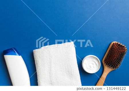 cosmetic for hair care, cream and towel on a colored background top view. flat lay cosmetic for hair care, cream and towel on a colored background top view. flat lay 131449122