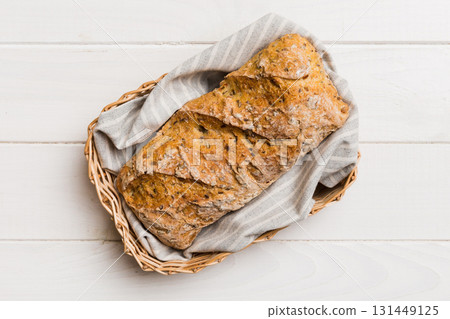 Freshly baked bread on basket against natural background. top view bread copy space 131449125