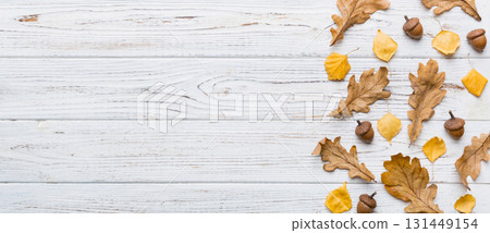 Autumn composition. Pattern made of dried leaves and other design accessories on table. Flat lay, top view Autumn composition. Pattern made of dried leaves and other design accessories on table. Flat lay, top view 131449154