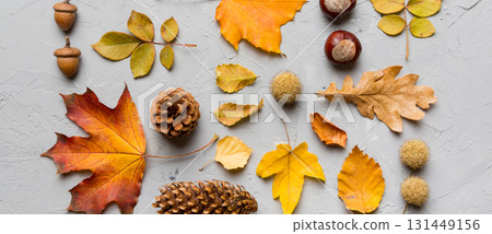 Autumn composition. Pattern made of dried leaves and other design accessories on table. Flat lay, top view Autumn composition. Pattern made of dried leaves and other design accessories on table. Flat lay, top view 131449156