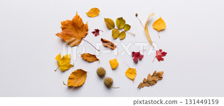 Autumn composition. Pattern made of dried leaves and other design accessories on table. Flat lay, top view Autumn composition. Pattern made of dried leaves and other design accessories on table. Flat lay, top view 131449159