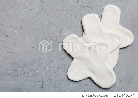 Eco-friendly reusable fabric women's pads. set of colorful bright reusable menstrual pads. zero waste woman periods concept top view with copy space Eco-friendly reusable fabric women's pads. set of colorful bright reusable menstrual pads. zero waste woman periods concept top view with copy space 131449174