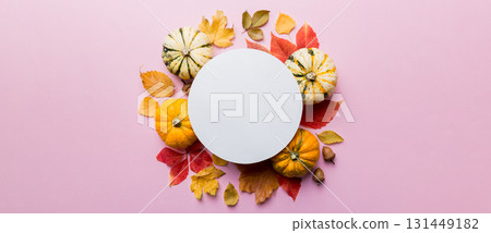 Autumn composition with round paper blank and dried leaves with pumpkin on table. Flat lay, top view, copy space Autumn composition with round paper blank and dried leaves with pumpkin on table. Flat lay, top view, copy space 131449182