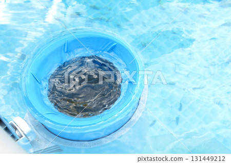 Top view of the blue skimmer for cleaning the pool in clear water. Contaminated pool cleaning concept 131449212