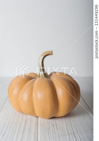 Minimalist Autumn Pumpkin Decoration on White Wooden Table 131449296
