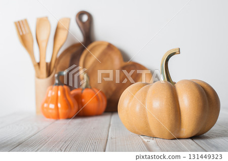 Autumn Kitchen Decor with Wooden Utensils and Ceramic Pumpkins Autumn Kitchen Decor with Wooden Utensils and Ceramic Pumpkins 131449323