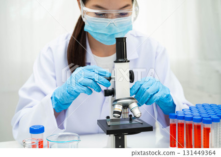 Scientist medical professional use microscope for research in science laboratory. 131449364