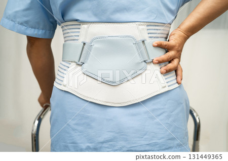 Asian senior pain back wearing elastic support belt with walker. Asian senior pain back wearing elastic support belt with walker. 131449365