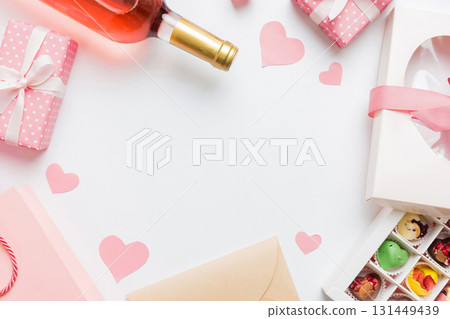 top view photo of st valentine day decor shopping, bag, wine, bottle, envelope, gift, box, candy and red heart on colored background with empty space. Frame background top view photo of st valentine day decor shopping, bag, wine, bottle, envelope, gift, box, candy and red heart on colored background with empty space. Frame background 131449439