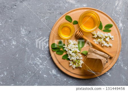 honey jar with acacia flowers and leaves. fresh honey top view flat lay honey jar with acacia flowers and leaves. fresh honey top view flat lay 131449456