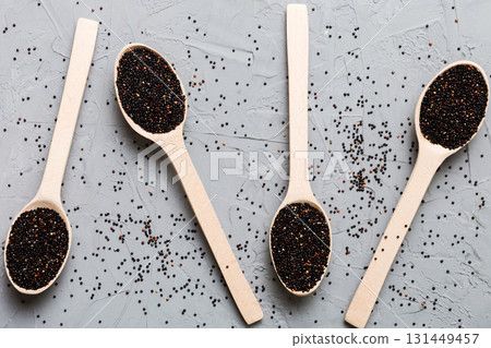 quinoa seeds in bowl and spoon on colored background. Healthy kinwa in small bowl. Healthy superfood 131449457