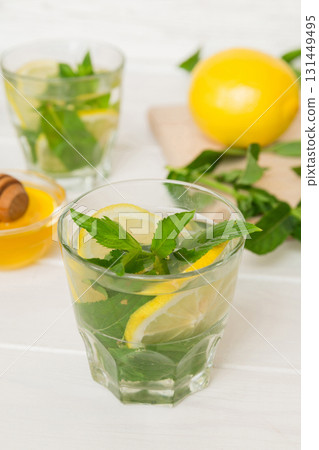 Mojito cocktail. Refreshing mojito cocktail with lime, lemon and mint in a tall glass with a stick 131449495
