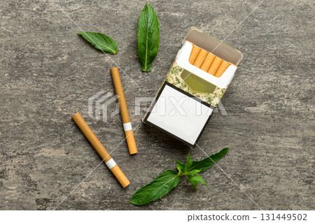 Pack of menthol cigarettes and fresh mint on colored table, Menthol cigarettes top view flat lay 131449502