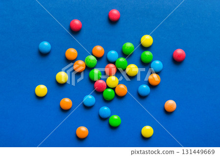 Mixed collection of colorful candy, on colored background. Flat lay, top view. frame of colorful chocolate coated candy Mixed collection of colorful candy, on colored background. Flat lay, top view. frame of colorful chocolate coated candy 131449669