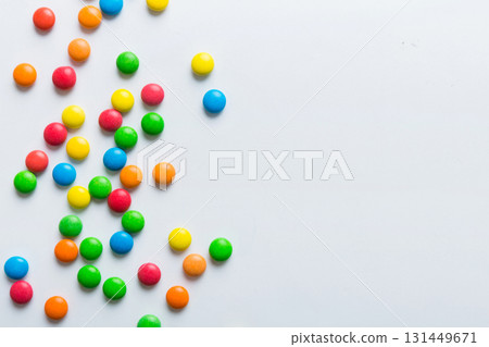Mixed collection of colorful candy, on colored background. Flat lay, top view. frame of colorful chocolate coated candy 131449671
