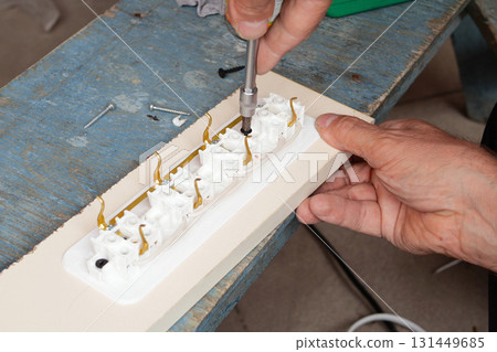 man making an extension cord socket outdoor 131449685