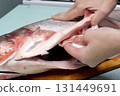 Cooking silver carp. cleaning ribs and blotting its insides with a napkin 131449691