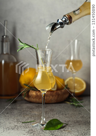 Italian liqueur Limoncello with fresh lemons and rosemary branches. 131450890