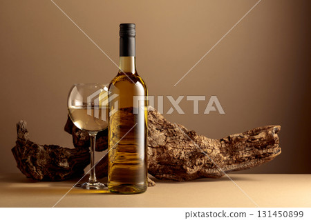 White wine and old snag on a beige background. 131450899