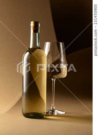 Bottle and glass of white wine. 131450900