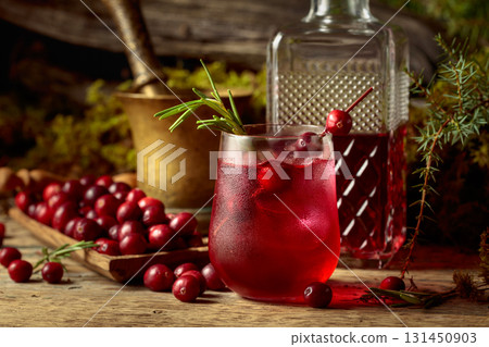 Cranberry cocktail with natural ice and rosemary in frozen glass. 131450903