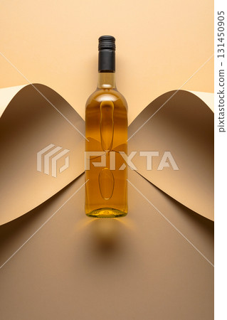 Bottle of white wine on a beige background. 131450905