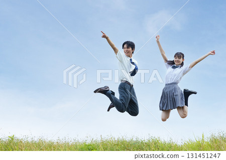 High school students jumping against the blue sky 131451247