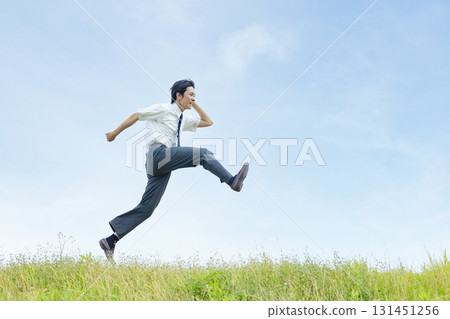 High school students jumping against the blue sky 131451256