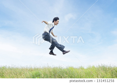 High school students jumping against the blue sky 131451258