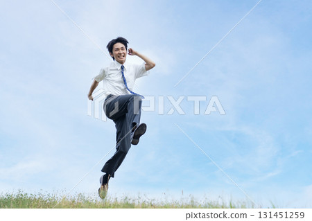 High school students jumping against the blue sky 131451259
