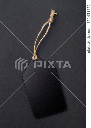 Empty black tag on black background 131451352