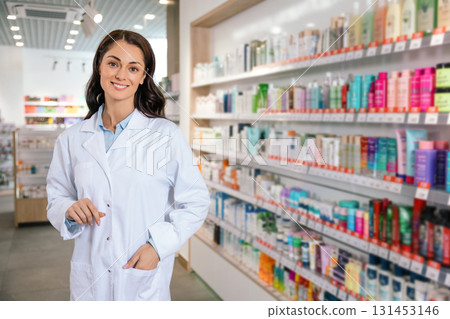 Smiling female pharmacist standing confidently in drugstore 131453146