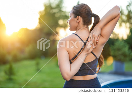 Waist up of a woman stretching her arms while doing yoga 131453256