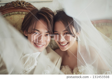 Smiling bride and groom taking a commemorative photo 131453508