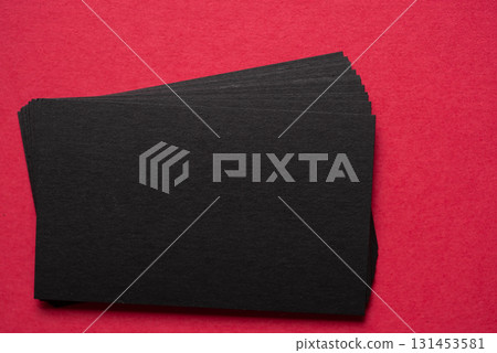 Black cards lined up on a red background Black cards lined up on a red background 131453581